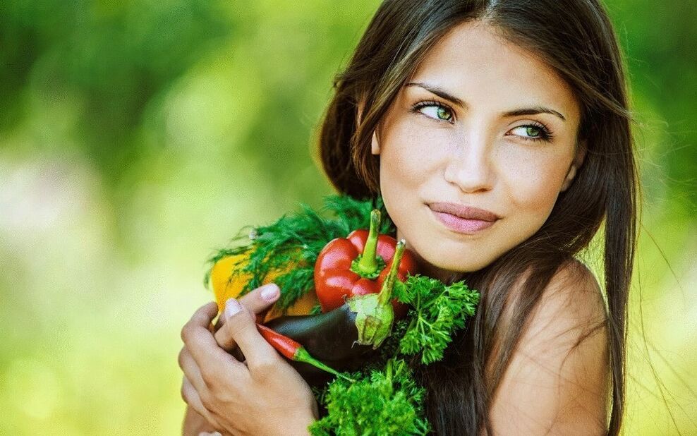 girl holding vegetables to clean the body of parasites. 